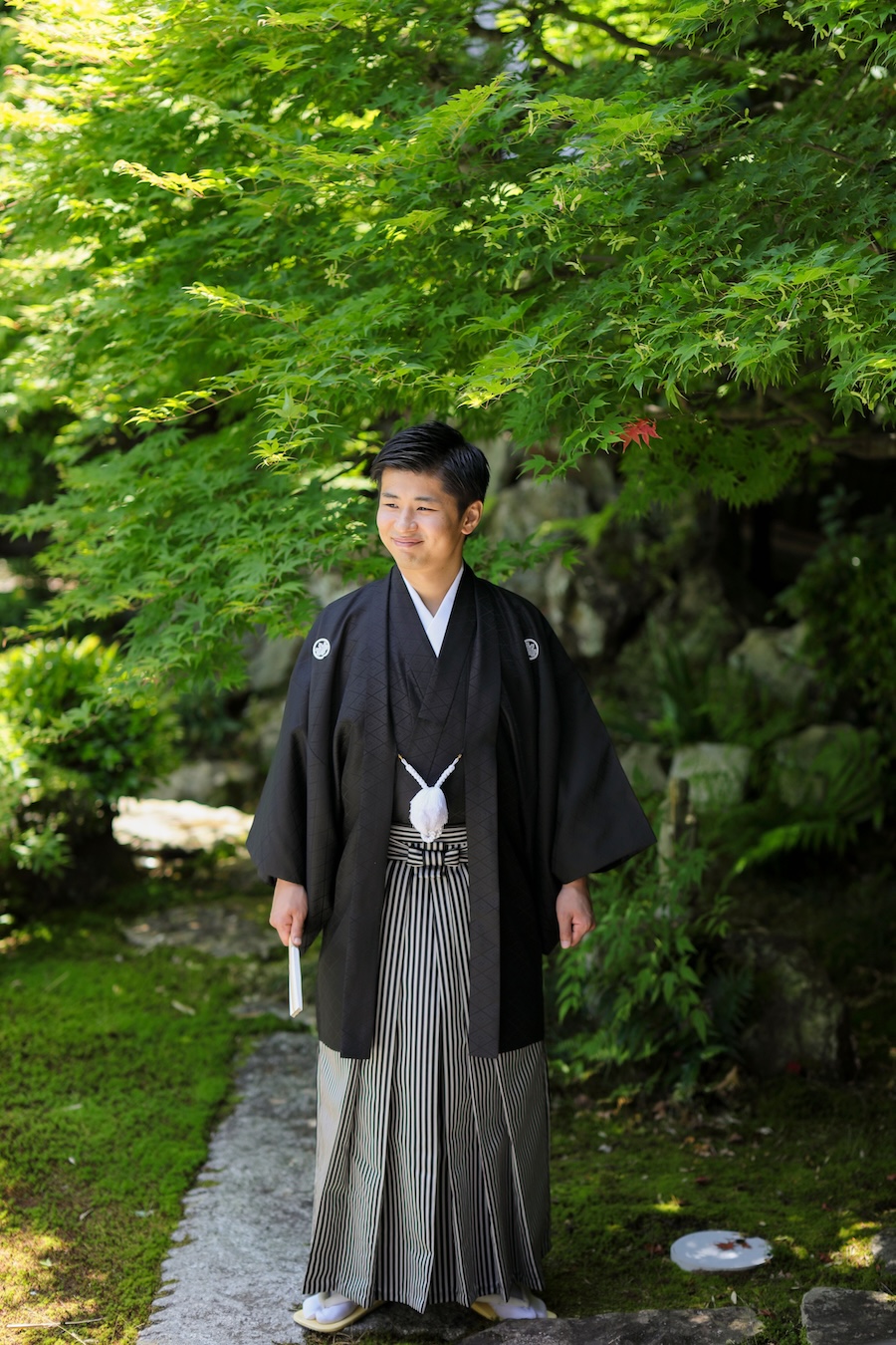 新緑を背景に羽織袴姿の新郎様