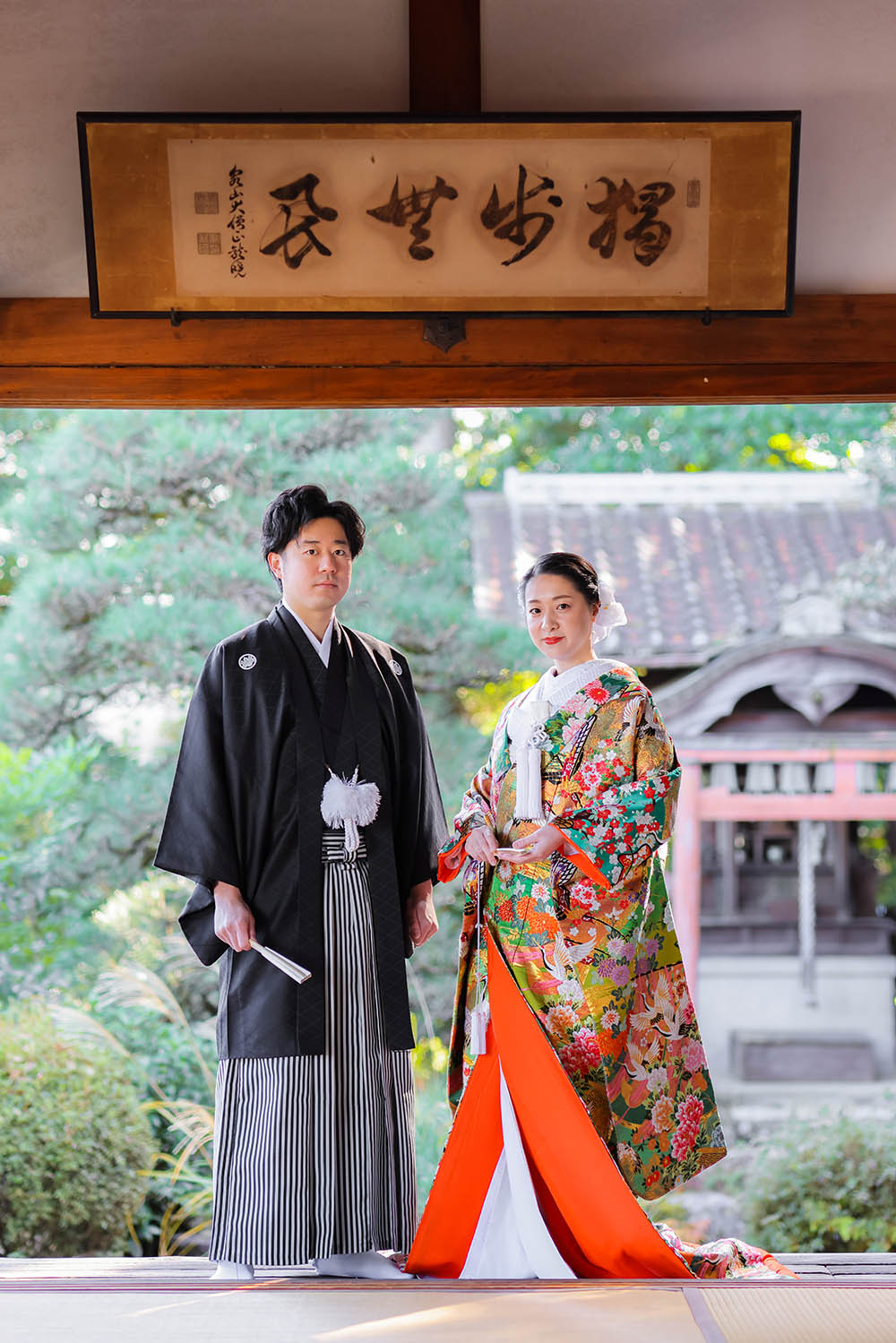 京都戒光寺のお庭を背景に色打掛と羽織袴姿のカップル様